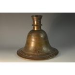 An Islamic bronze bell shaped hookah base, chased with a band of scrolling leafy branches,