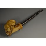 A 19th century Meerschaum pipe, the bowl carved as the head of a Nubian, wearing a fez,