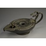 A 19th century dark patinated lamp, in the Roman manner,