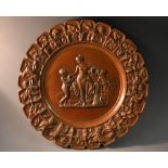 An early 20th century circular plaque, cast with Venus and attendants,