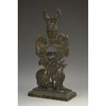 A 19th century brass pocket watch stand, cast throughout with triumphal regalia, rectangular base,