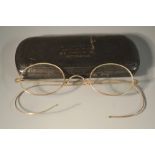 A pair of 9ct rose gold mounted spectacles, gold flexible wire ear pieces, stamped 375,