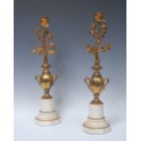 A pair of 19th century ormolu and marble candlesticks, cast as flowering urns,