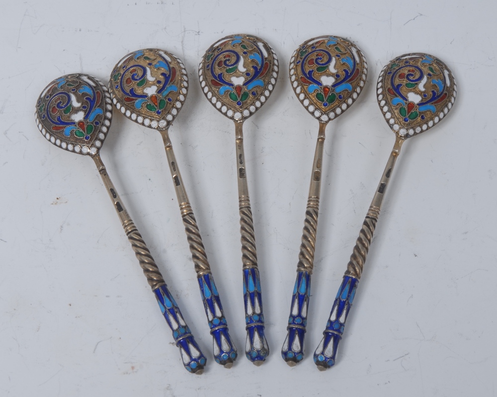 A set of five Russian silver-gilt and niello spoons, each brightly decorated in polychrome enamels,