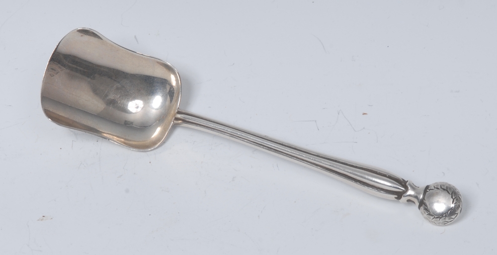 An Arts and Crafts silver caddy or sugar spoon, bun shaped terminal, lobed stem, shovel shaped bowl,