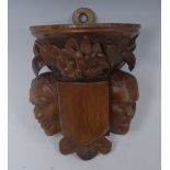 A 19th century French walnut wall bracket, carved as a corbel,