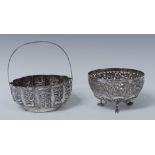 An Indian silver coloured metal lobed sweetmeat basket, embossed with stylised birds,