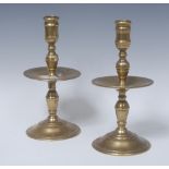 A near pair of 18th century brass heemskerk candlesticks, knopped sconces and columns,