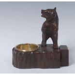 A Black Forest novelty table vesta, with a bear, hiking, dished brass liner, rustic base, 11.