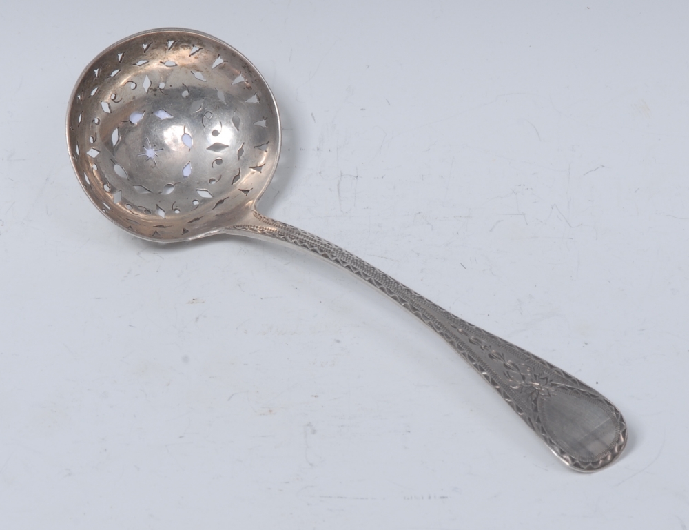 A George IV Irish silver Bright-cut Old English pattern sifter spoon, 19cm long, James Le Bas,