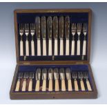 A George V silver fish service, comprising twelve pairs of knives and forks,