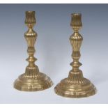 A pair of 18th century brass table candlestick, of seamed construction, fluted sconces and pillars,