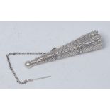 A 19th century Indian silver coloured metal posy holder, embossed with acanthus, 12cm long,