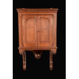 A Victorian oak wall hanging wig cupboard,