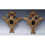 A pair of Austrian giltwood double headed eagle mirrors, set with 9cm oval mirrors, crown crestings,