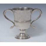 A George III provincial silver bell shaped loving cup, scroll capped handles, three-quarter girdle,