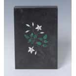 A Derbyshire Ashford marble rectangular deskweight, inlaid in malachite and white stone with lilies,