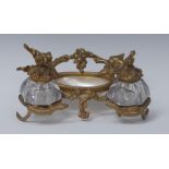 A 19th century ormolu and mother of pearl inkstand, cast with serpents and fruiting vine,