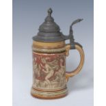 A Metlach cylindrical tankard,incised with frolicking Bacchanalia figures, on a tan ground,.