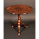 A George III mahogany occasional table, the circular top tilting on baluster column, tripod legs,