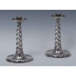 A pair of Arts and Crafts silver candlesticks,