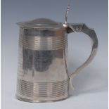 A George III silver spreading cylindrical tankard, hinged domed cover,