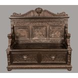 A 19th century oak box settle, shaped cresting, panelled back,