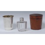 A George III silver travelling beaker and flask, the faceted cut glass bottle with hinged cover,