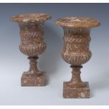 A pair of marbled stone half-fluted campana pedestal vases, rope-twist girdles, square bases, 29.