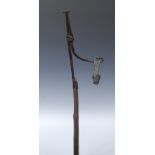 A 19th century wood and iron floor standing nip rush light holder, cruciform base,