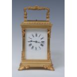 A French gilt brass quarter-repeating carriage clock, white dial with Roman numerals,