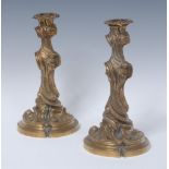 A pair of 19th century Rococo Revival ormolu candlesticks, cast throughout with scrolls,