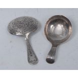 A George III silver caddy spoon, the bowl engraved with shield cartouche and stylised foliage,