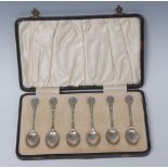 A set of six George V silver and enamel coffee spoons,