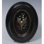 A 19th century Ashford type marble oval plaque, inlaid in specimen stones with a spray of flowers,