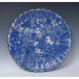 A Japanese fluted shaped circular charger, decorated in underglaze blue with elders,