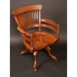 A 19th century walnut swivel desk chair, slatted back, reeded rails to arms, shaped legs, c.