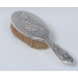 A Chinese silver hair brush, embossed with leafy branches, 24.