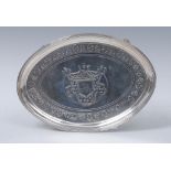 A George III oval card waiter, engraved and chased with crest, banded with stylised foliage,