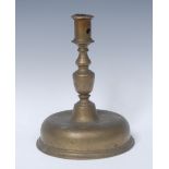 A 17th century brass candlestick, cylindrical socket, knopped stem, domed base, 22cm high,