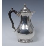 A George III silver baluster wine flagon or water jug, hinged domed cover with acanthus knop finial,