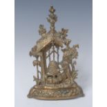 A 19th century gilt brass pocket watch stand, cast as a bear beside a honey skep,