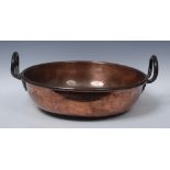 A 19th century copper pan, rolled rim, steel handles, 55cm diam, c.