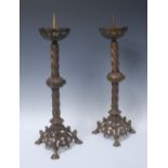 A pair of French Gothic Revival gilt metal pricket candlesticks, in the ecclesiastical taste,