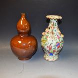 A Chinese double gourd vase, glazed throughout in brown, 24.