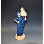 A Royal Worcester Cairo water carrier figure, modelled by James Hadley, blue glazed gown,