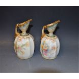 A matched pair of Doulton Burslem ewers decorated with flowers,