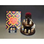 A set of fifteen Royal Crown Derby thimbles on stand, various patterns, 1128, 2451, Mikado, Posie,