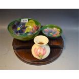 Moorcroft - a Clematis pattern bowl, 16cm diameter; a Moorcroft Orchid pattern bowl, 12cm diameter,