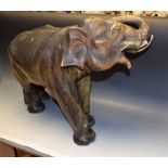 A large Royal Dux type model of an Indian elephant, standing with curled trunk,